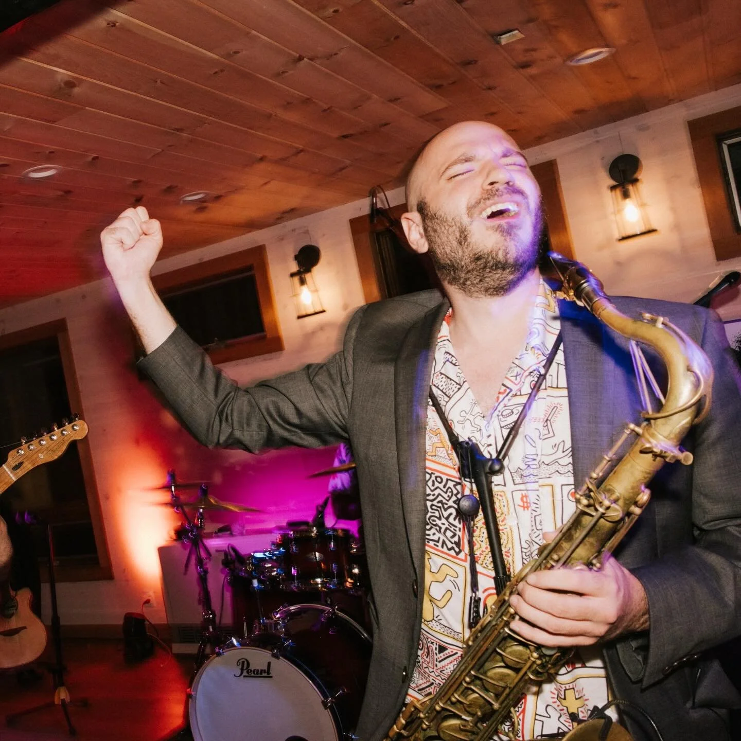 Saxophone player mid-solo with the band behind him