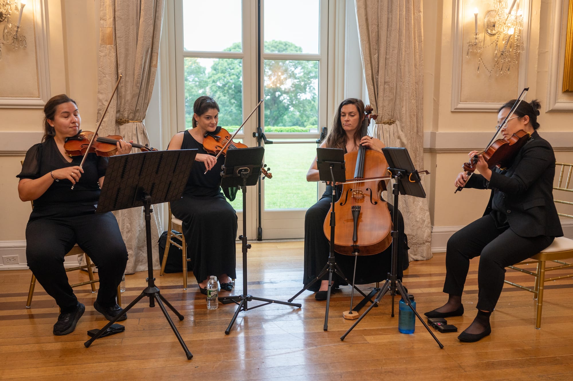 String quartet playing at a wedding ceremony in an elegant estate room