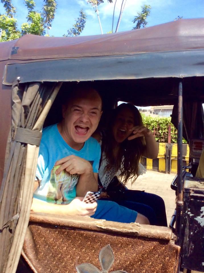 Tino and Emily laughing in a tuk-tuk on tour